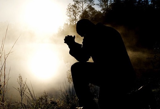 Deep Surrender to God: Woman Kneeling in Prayer