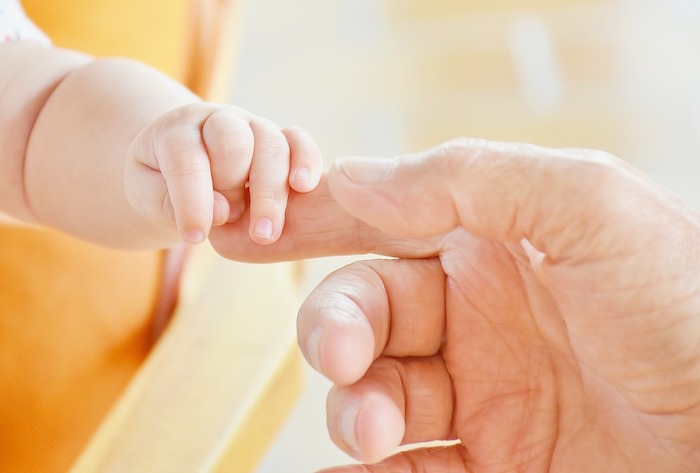 Salvation: How Can I Stay Saved? Baby Clinging to Adult Hand